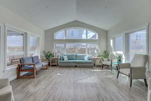 Sunroom featuring vaulted ceiling