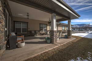 Snow covered patio with a mountain view