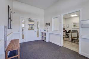 Entryway with dark colored carpet