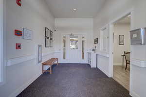 Entrance foyer featuring carpet