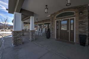 Doorway to property with covered porch