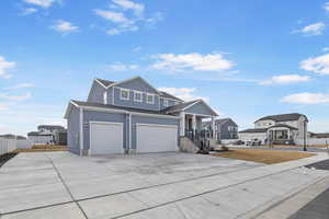 View of front of property with a garage and a porch