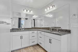 Bathroom featuring vanity, a shower with shower door, and hardwood / wood-style floors