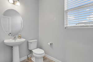 Bathroom featuring hardwood / wood-style flooring, toilet, and sink