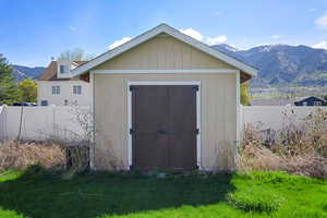 View of shed featuring a mountain view and a fenced backyard