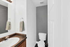 Bathroom with tile patterned flooring, vanity, and toilet