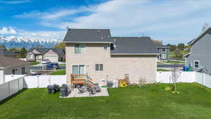 Rear view of house with a patio, a gate, and a fenced backyard