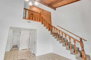 Stairway featuring beamed ceiling and wooden ceiling