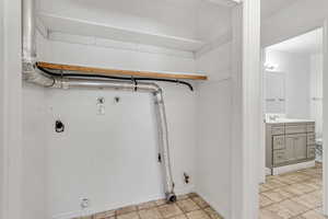 Laundry area featuring gas dryer hookup, sink, hookup for a washing machine, and hookup for an electric dryer