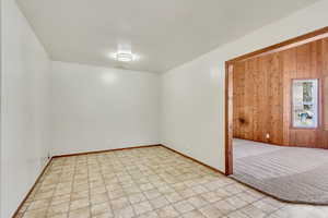 Empty room featuring wood walls