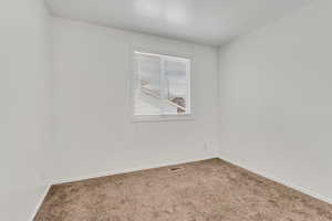 Unfurnished room with carpet