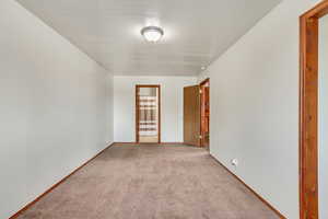 Unfurnished room with light carpet