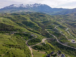 Aerial view of property's location featuring a mountainous background