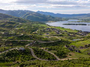 Aerial view of property's location with a water and mountain view