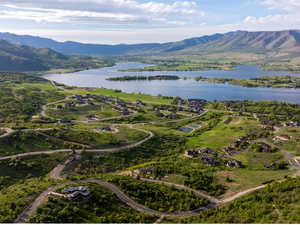 Aerial view of property and surrounding area with a water and mountain view
