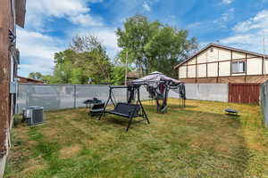 View of yard with cooling unit and a fire pit