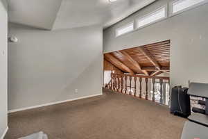 Unfurnished office featuring wooden ceiling, beamed ceiling, and carpet flooring