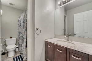 Bathroom featuring vanity and toilet