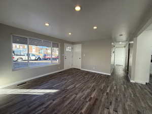 Interior space with dark hardwood / wood-style flooring