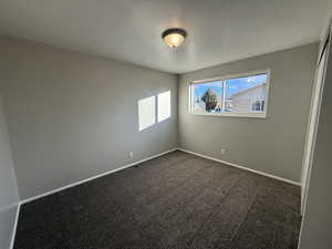 Unfurnished room with carpet flooring