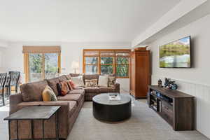 Living area with wainscoting and light colored carpet