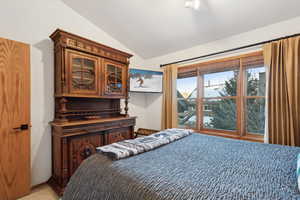 Bedroom with lofted ceiling