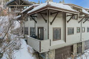 Snow covered property featuring a garage