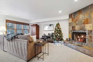 Carpeted living room with a fireplace