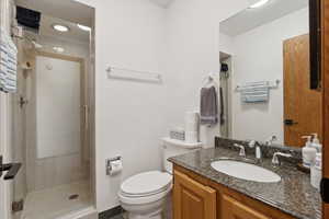 Bathroom with a stall shower and vanity