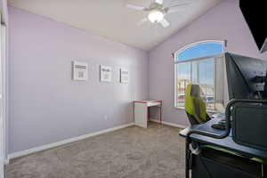 Office space featuring lofted ceiling, light colored carpet, and ceiling fan