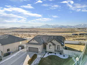 View of front of house with a mountain view and a garage