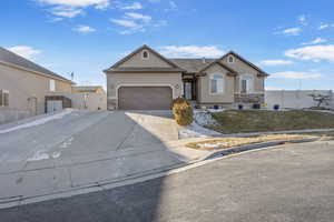 Single story home featuring a garage and a front yard