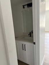 Bathroom featuring hardwood / wood-style flooring and vanity