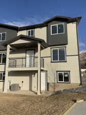 Rear view of property with a balcony and central AC unit