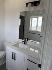 Bathroom featuring vanity and toilet