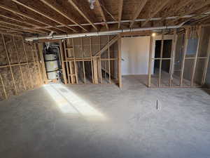 Basement featuring water heater and electric panel