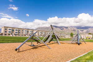 View of play area featuring a mountain view and a yard