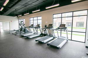Gym with a wealth of natural light and a towering ceiling