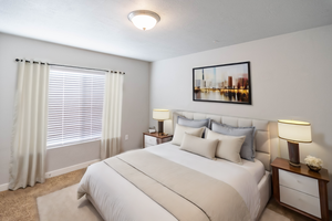 Bedroom featuring light carpet