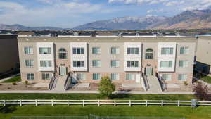 View of front of house with a mountain view and a front lawn
