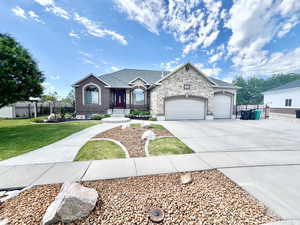 View of front of house with a garage and a front yard