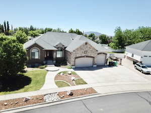 View of front of property featuring a garage and a mountain view