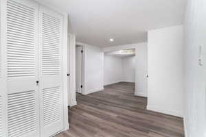 Hall with dark hardwood / wood-style flooring