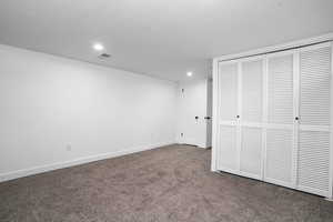 Unfurnished bedroom with carpet and a closet