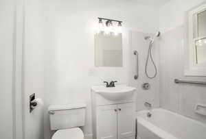 Full bathroom with toilet, shower / bath combination, and vanity