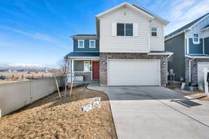 View of front of house with a mountain view and a garage