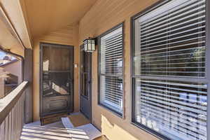 View of exterior entry featuring a balcony