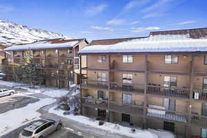 Snow covered building with a mountain view