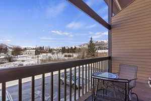 Snow covered back of property featuring a mountain view