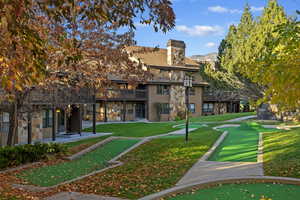 Surrounding community with a mountain view and a yard